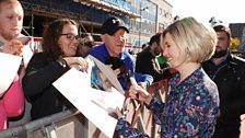 Jodie Whittaker signing autographs on the red carpet.