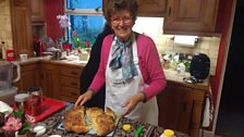 Norah sharing out her home made Cheddar and Thyme Soda Bread