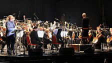 Ed Balls on stage with the tv Concert Orchestra