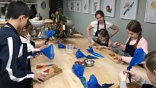 The children busy at work icing their Christmas tree decorations