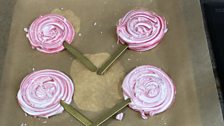 Meringue lollipops sprinkled with candy cane