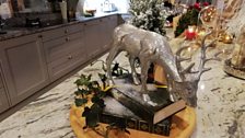 A Christmas Centerpiece with books and a deer drinking at a mirror lake