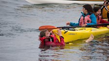 Kayakers to the Rescue - Tom and Charlotte holding onto other kayaks after surviving the whale breaching onto them