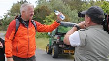 Derek celebrating the finish of the sponsored walk with cameraman Rob McDougall