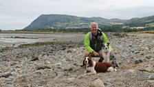 Derek with Search and Rescue Dogs, the two Izzies, on the beach near Abergyngregyn