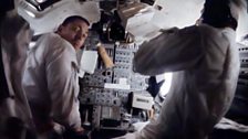 Jack Swigert (left) and Jim Lovell sit across the Lunar Module's control panel.