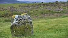 “A headstone marking the graves of fallen Jacobite soldiers at the Culloden battlefield.”