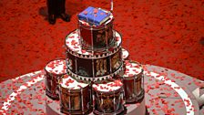 The poppy petals fall on the Book of Remembrance and drum altar