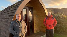 Derek and site owner Mark Whitehouse in front of a glamping pod