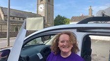 Amy looks a bit windswept but is ready for the start as she stands in front of the church....