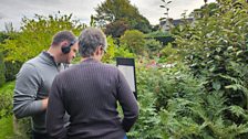 David and head gardener Jenifer reading the poetry in the garden