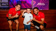 Mariners fan Reggie poses with players