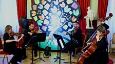 Players from the Ulster Orchestra performing a medley of book-themed music at the Belfast Harbour Office during Book Week 2023.