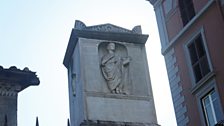 An 11 year old poet overlooks the busy Roman street named after him