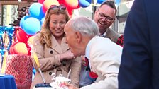 Charlie Ross blowing out anniversary cake candles