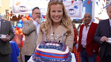 Christina Trevanion carefully carries the Bargain Hunt 25th birthday cake