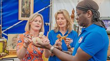 Kate Bliss, Jo Caulfield and Stephen K Amos examining items during their shop