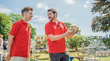 Russell Kane and Ignacio Lopez holding a replica skull during their shop