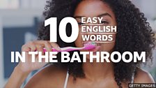 10 easy words bathroom and a woman brushing her teeth