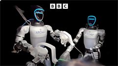 Surgeons remotely control two human-like robots in an operating theatre