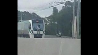 Man survives 25km ride hanging on to side of German train