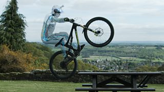 man doing wheelie on mountain bike.