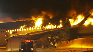 pictures of plane on fire on Tokyo runway