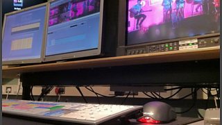 Three screens with video editing software showing on them.