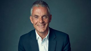 A man in a navy blue suit.