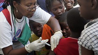 A nurse injecting a child in Africa