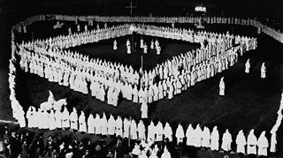 KKK members standing in a square formation at a rally in West Virginia, 1924