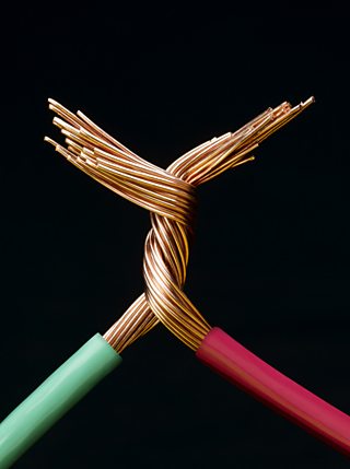 Two electrical cables with copper wires twisted together