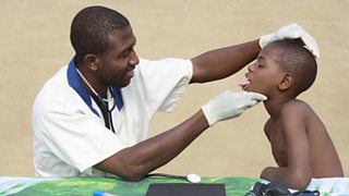 Doctor checking boys mouth in Mali, Africa