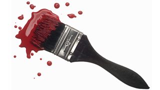 Red paint dipped paint brush