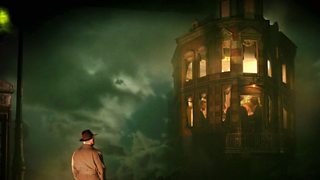 Picture from a stage production of An Inspector Calls with Inspector Goole standing outside the Birlings home in the fog.