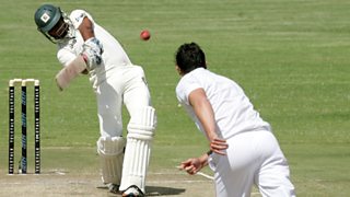 A cricket bowler aims a ball at a batsman