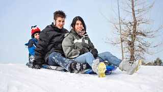 Three children playing and having fun outdoors during winter time
