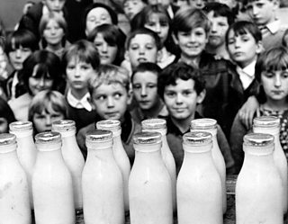 Photo of children waiting for their daily bottle of milk. Circa 1970
