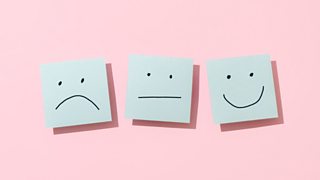 A sad face; a neutral face; a happy face.