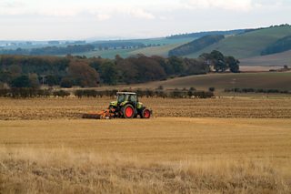 A tractor ploughing a field in the lowlands