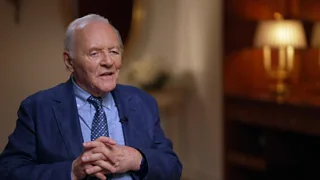 Anthony Hopkins sat on a chair with his hands together