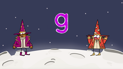 On the moon, two happy wizards, one purple, one red, stand next to the letter &#39;g&#39;