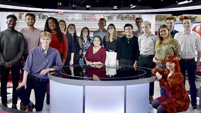 Group of BBC apprentices standing in a News studio
