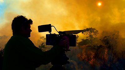 Cameraman John Shier filming a grass fire in Brazil’s cerrado