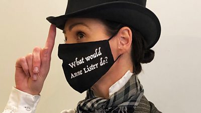 Suranne Jones in costume wearing a facemask saying 'what would Anne Lister do?'