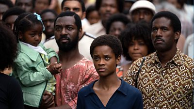 Letitia Wright as Altheia Jones amongst a crowd