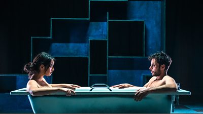 Egyptian Adam (Yasmin Al-Khudhairi) and Adam (Adam Kashmiry) in a bath looking at each other