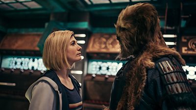 Jodie's Whittaker's Doctor faces off against Karvanista, a large dog-like alien with the head of a dog and body of a man.