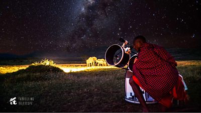 Maasai with telescope at night, and elephants