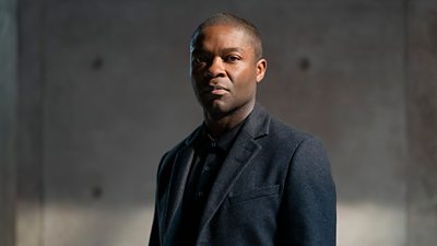 David Oyelowo plays Edward in The Girl Before. He wears a dark suit jacket and dark shirt.